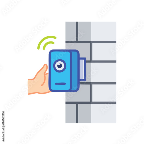 Hand installing a wireless security camera on a brick wall.