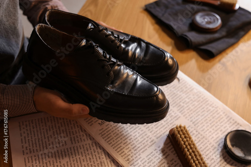 Male shoemaker polishing sh...