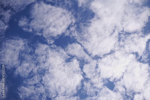 Fluffy White Clouds in a Bright Blue Sky on a Sunny Day.
