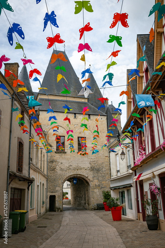 the shopping street in la ferte bernard with the the Saint Julien gate