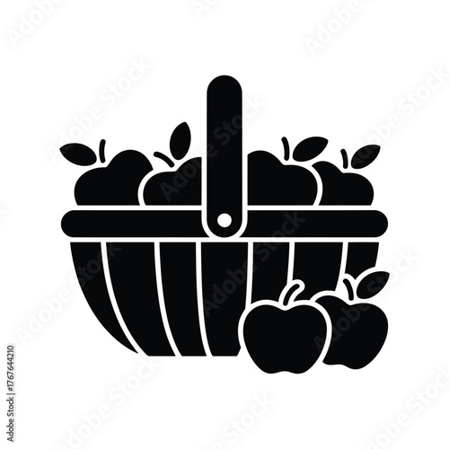 Black silhouette of a basket filled with apples and a few apples outside