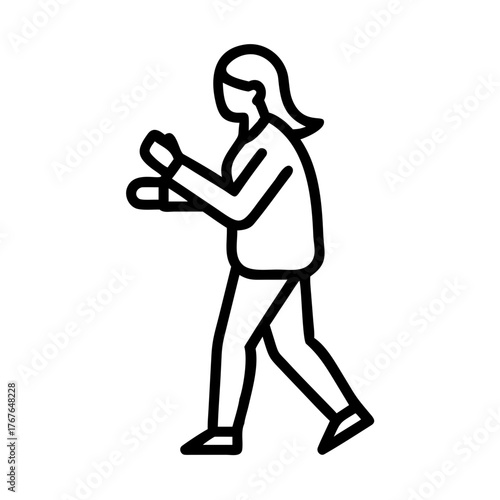 Businesswoman checking her smartwatch while walking outdoors