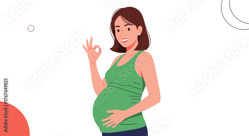 Smiling pregnant woman in a green tank top holds her belly and gives an ok sign.