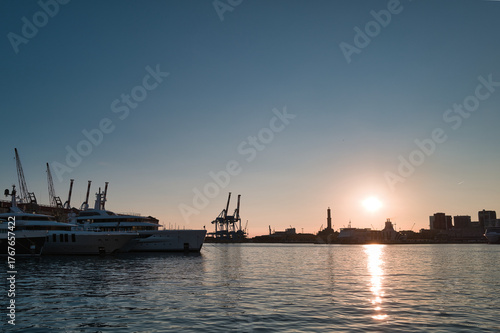 harbor with lighthouse of Genoa at sunset in Italy