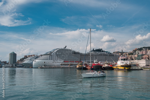 Port of Genoa in sunshine with cruise ship and sailboat