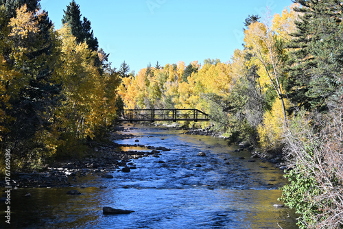 Pedestrian Bridge over River in the Fall