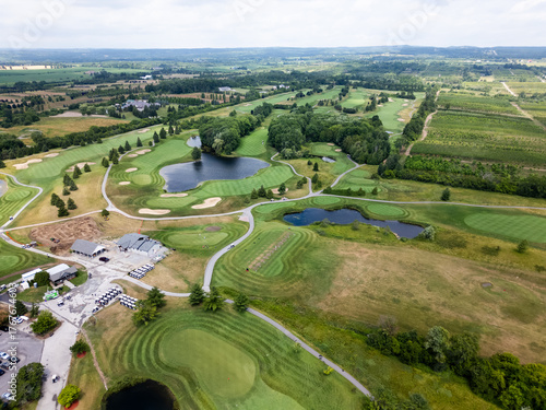 Aerial View of Scenic Golf Course with Water Hazards and Rolling Greens