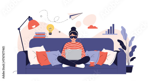 A young woman wearing smart glasses works remotely on her laptop from a cozy home couch, surrounded by creative ideas and digital productivity.