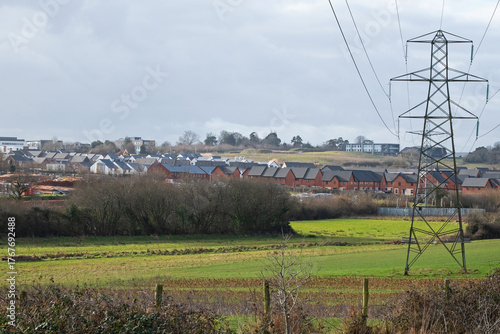 Urban development in the form of a new housing estate encroaching on farmland near Exeter. Housebuilding on  such rural sites has become a controversial issue in the UK