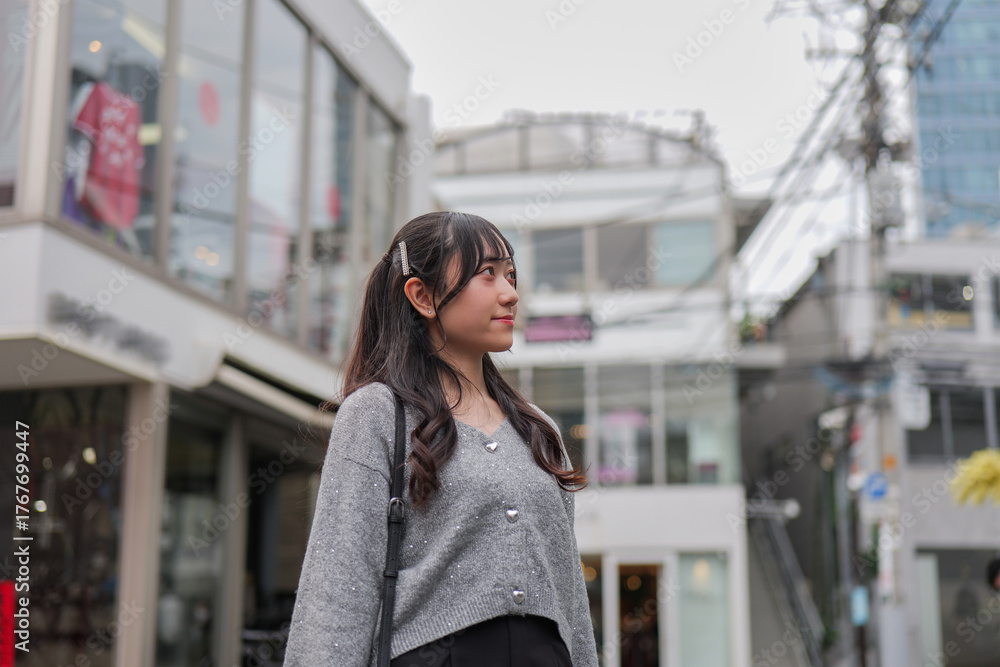 Fototapeta premium Woman strolling through a Harajuku side street