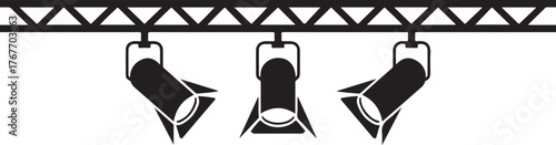 Black stage lighting spotlights suspended from a truss white