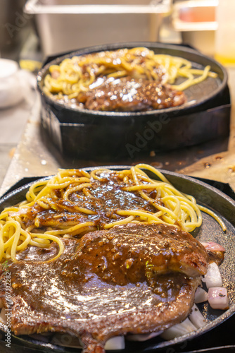 cooking steak spaghetti at vertical composition