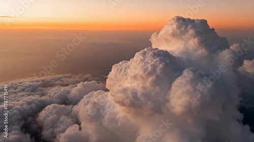 Majestic Cumulonimbus Cloud Formation Illuminated by Golden Sunset Horizon Sky
