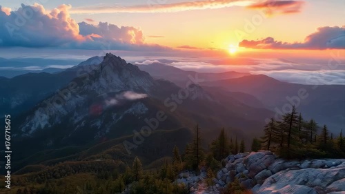 Majestic Mountain Range at Sunset With Golden Hour Lighting And Dramatic Clouds Over Rugged Peaks And Rocky Outcrop In Foreground