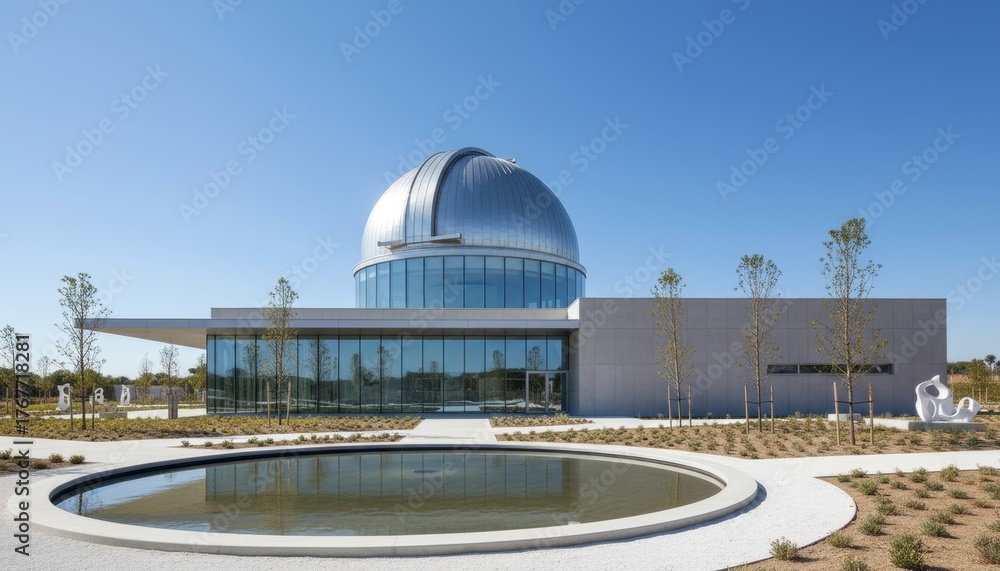 Obraz premium Modern architectural observatory building with a large dome, surrounded by landscaped gardens and a reflective pond, showcasing innovative design and natural integration