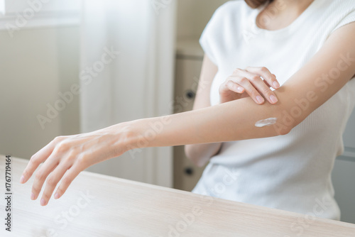 Wallpaper Mural Health skin care, beauty asian young woman, girl hand applying, putting moisturizer on her arm, elbow after shower bath in room at home. Skin body cream moisturizing lotion, routine in morning. Torontodigital.ca