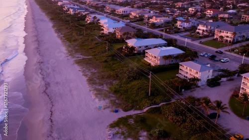 Oceanfront Coastal Town With Beach Houses And Ocean Waves At Dusk Aerial View