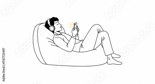 Person relaxing on beanbag chair while listening music with smartphone and headphone