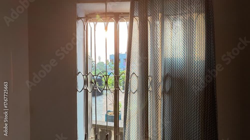 Sunrise or Sunset View from an Apartment Window with Decorative Iron Bars