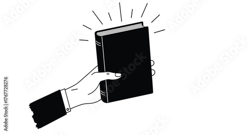 A hand in a suit sleeve holds up a closed black book with radiating lines of light.