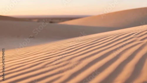 Soft Sand Dunes Textured Ripples Under Warm Golden Sunset Light Casting Long Shadows Across Desert Landscape