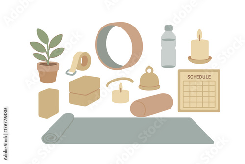 Set of yoga and meditation accessories including mat blocks strap wheel and wellness items