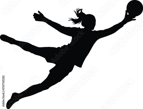 Silhouette of a female athlete in mid air diving to catch a ball during a sports game