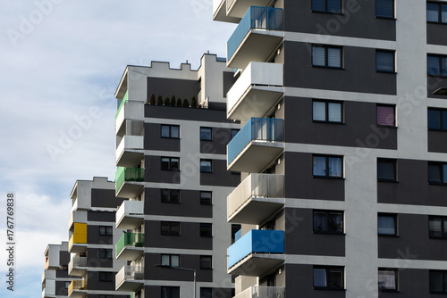 Contemporary apartment buildings with colorful balconies in blue, green, and yellow tones, representing modern urban architecture and city residential design