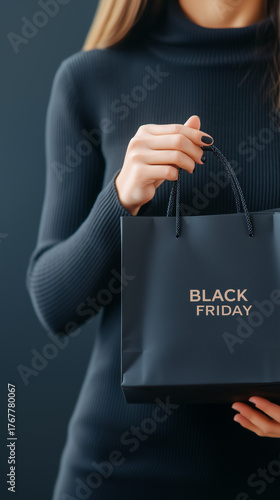 Elegant Woman in Black Outfit Holding Luxury Black Shopping Bag with Black Friday Typography, Vertical Studio Shot, Stylish Retail and Marketing Concept, Luxury Seasonal Sale and Promotion.