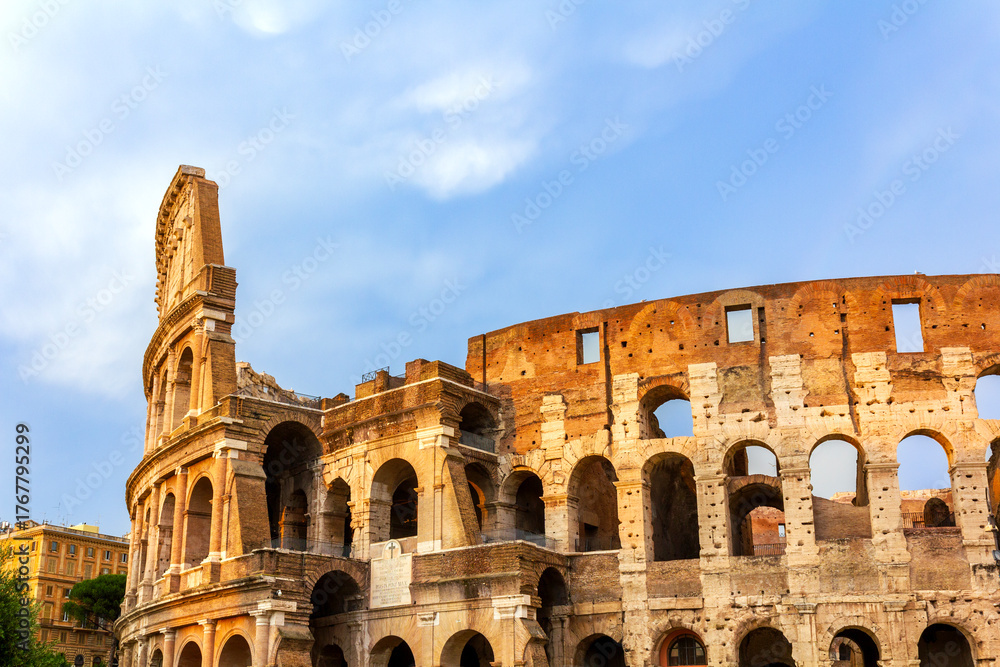 Fototapeta premium Imposing facade of the historic Colosseum in Rome, Italy, showcasing its distinctive architectural layers and timeless beauty. 