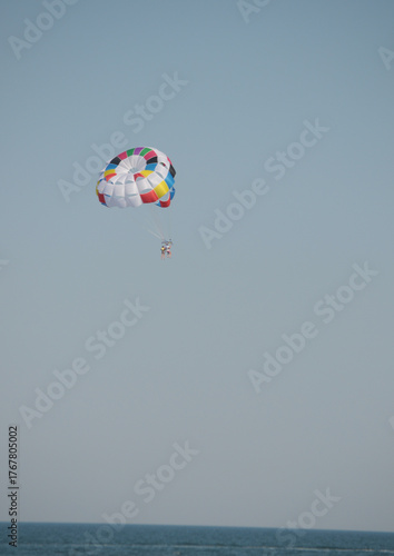 Colorful parasailing adventure over blue ocean water