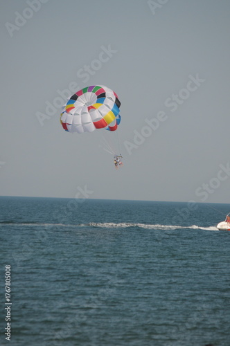 Colorful parasailing adventure over blue ocean water