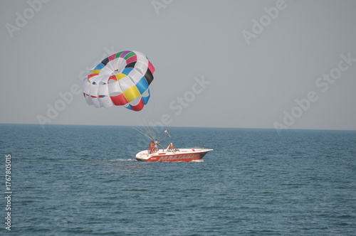 Colorful parasailing adventure over blue ocean water