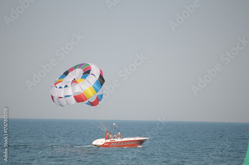 Colorful parasailing adventure over blue ocean water