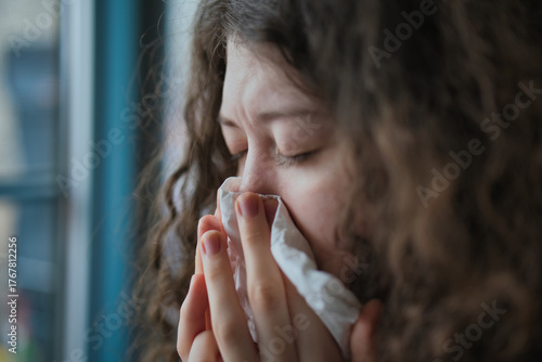 Tableau sur toile Sick woman blowing nose at home, cold flu allergy symptoms health care concept