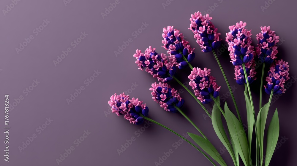 Obraz premium Vibrant bouquet of purple flowers arranged elegantly on a soft purple background, showcasing intricate petal details and lush green leaves, perfect for decorative or artistic purposes