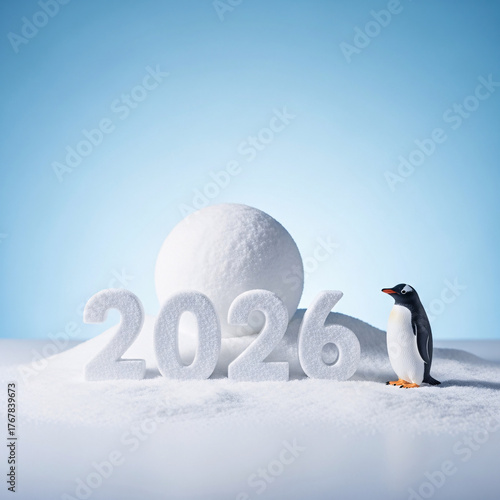 A cute penguin stands next to sparkling 2026 numbers on a snowy surface with a large snowball in the background, celebrating the new year