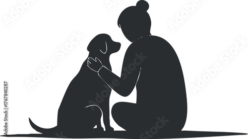 Silhouette of a person sitting with a dog showing affection and companionship.