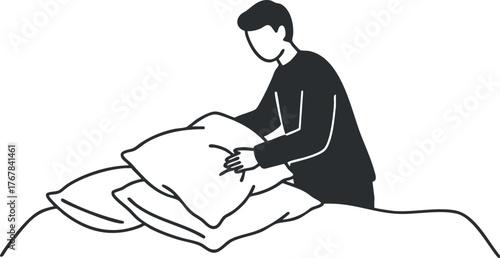 A man arranging pillows on a bed in a cozy home environment for a neat appearance.