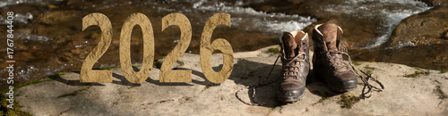 Rocky 2026 on a mountain riverside with a pair of trekking shoes ready for adventure. Active 2026 concept.