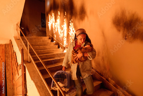 фотографія Woman escaping fire with baby and pet, running down stairs in smoke-filled building, emergency evacuation, rescue from burning building, dramatic scene, danger, motherhood
