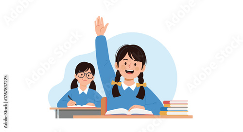 Two happy schoolgirls in uniforms are engaged in their lesson, with one actively raising her hand to answer a question.