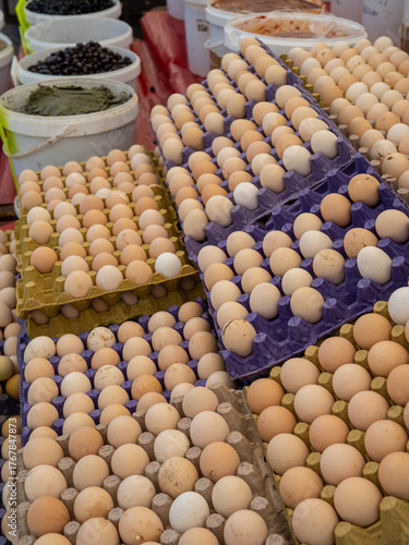 Stacked fresh chicken eggs on a market stall in Turkey. Vertical orientation