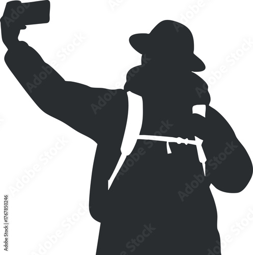 A silhouette of a person taking a selfie in a scenic outdoor setting.