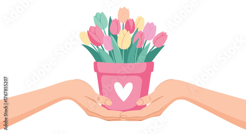 Hands hold a pink pot of colorful tulips with a white heart design.
