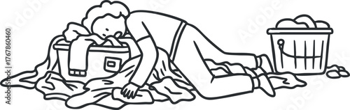 A person overwhelmed by a pile of laundry with clothes scattered around and a basket nearby.