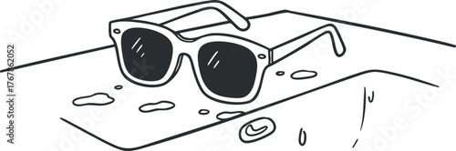 Sunglasses resting on a wet surface with water droplets, perfect for summer vibes and outdoor activities.