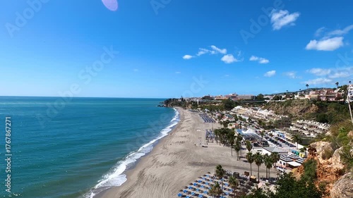 Wonderful landscapes of the shimmering sea and charming city unfold, offering breathtaking coastal views and a picturesque atmosphere in Nerja, Spain
