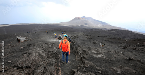 A young woman hiking and enjoying the beautiful scenery at Mount Etna, Sicily