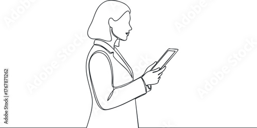 A professional woman using a tablet for business communication in a modern office setting.